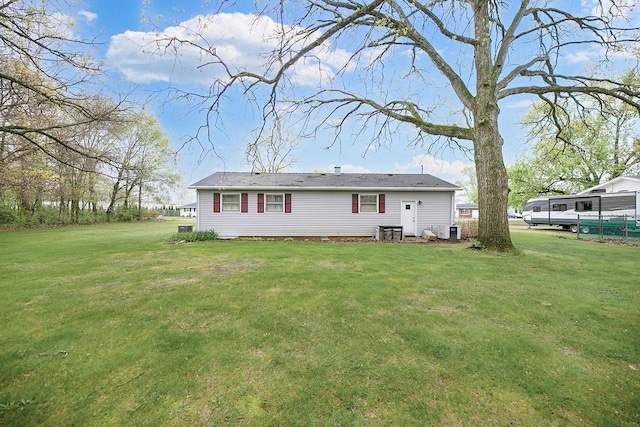 back of property featuring a yard