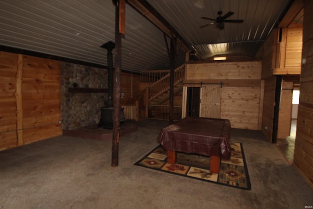 29623 County Road 6th Rd, Elkhart, IN 46514 - below grade area featuring a wood stove, wooden walls, a ceiling fan, carpet floors, and stairway