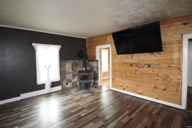 29623 County Road 6th Rd, Elkhart, IN 46514 - unfurnished living room featuring wooden walls, wood finished floors, a wood stove, and baseboards