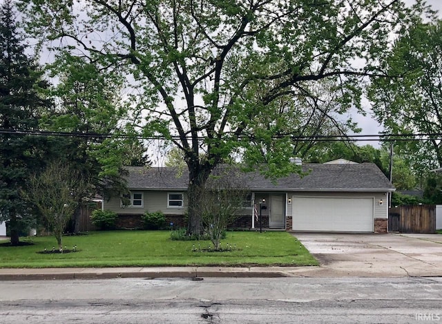 ranch-style house with fence, an attached garage, brick siding, driveway, and a front yard