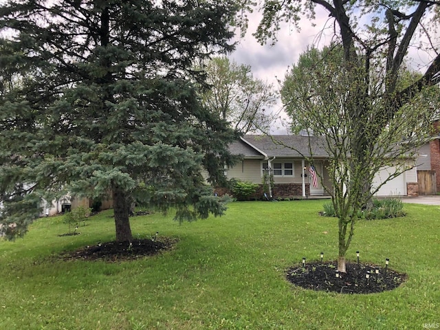 exterior space with driveway and a front yard