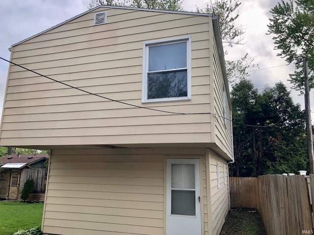 view of side of property featuring a yard and fence