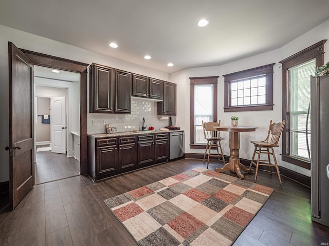108 S Church St, Owensville, IN 47665 - kitchen with a sink, dark wood-type flooring, dark brown cabinetry, light countertops, and appliances with stainless steel finishes
