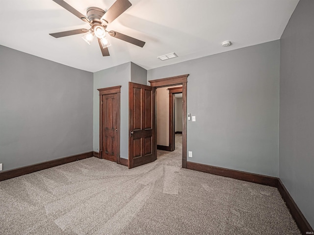 108 S Church St, Owensville, IN 47665 - unfurnished bedroom with baseboards, ceiling fan, light carpet, and visible vents