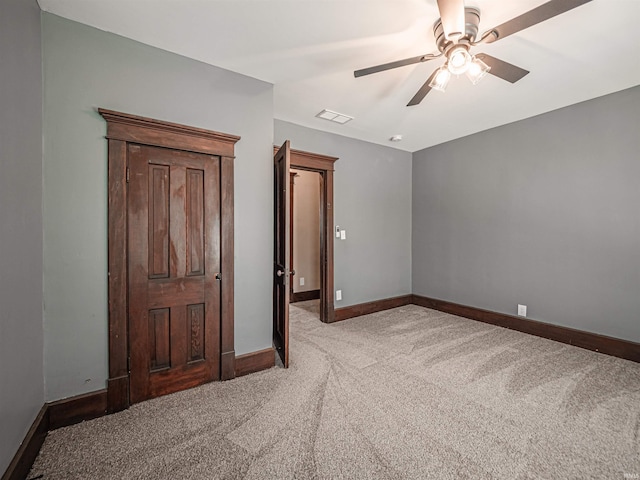 108 S Church St, Owensville, IN 47665 - unfurnished bedroom with baseboards, carpet flooring, visible vents, and a ceiling fan
