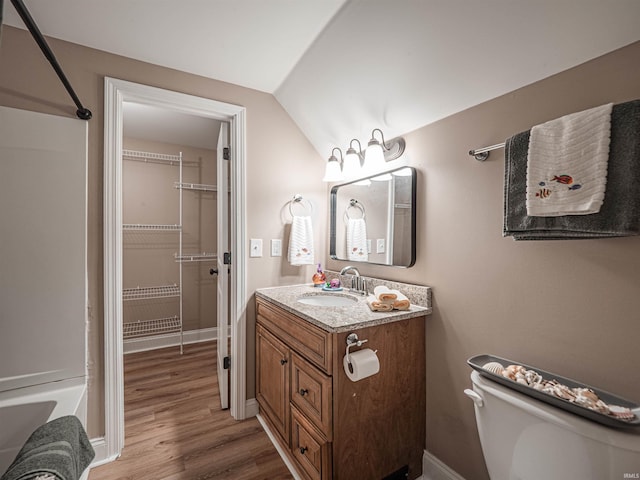 108 S Church St, Owensville, IN 47665 - bathroom with toilet, lofted ceiling, wood finished floors, vanity, and baseboards