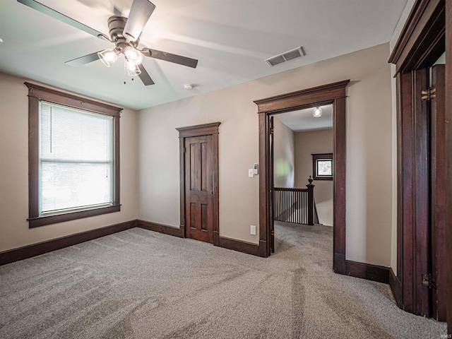 108 S Church St, Owensville, IN 47665 - unfurnished bedroom with multiple windows, visible vents, baseboards, and carpet floors
