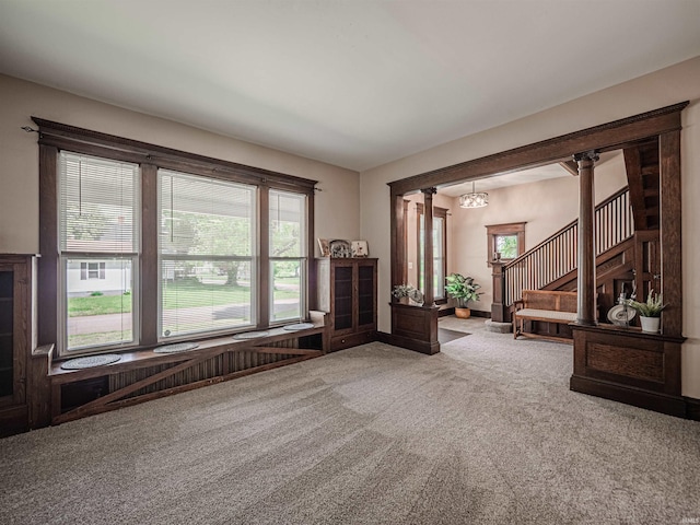 108 S Church St, Owensville, IN 47665 - interior space featuring stairs, carpet flooring, and a notable chandelier