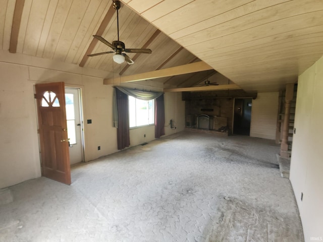 unfurnished living room featuring wooden ceiling, ceiling fan, a fireplace, and lofted ceiling with beams