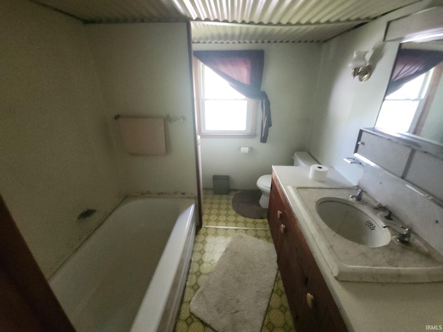 full bath with vanity, toilet, plenty of natural light, and tile patterned floors
