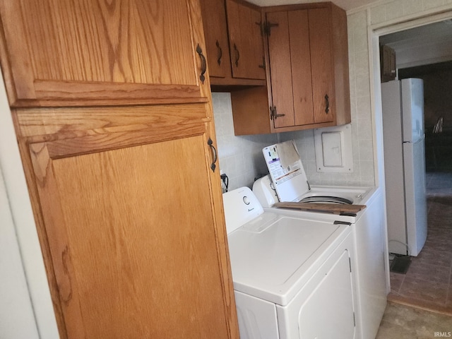 washroom with independent washer and dryer and cabinet space