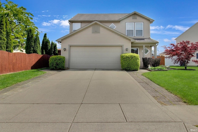 traditional-style home featuring concrete driveway, a garage, a front lawn, and fence