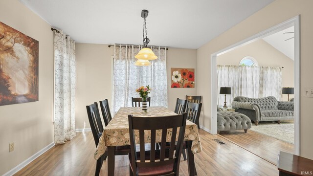 dining area featuring baseboards, visible vents, and wood finished floors