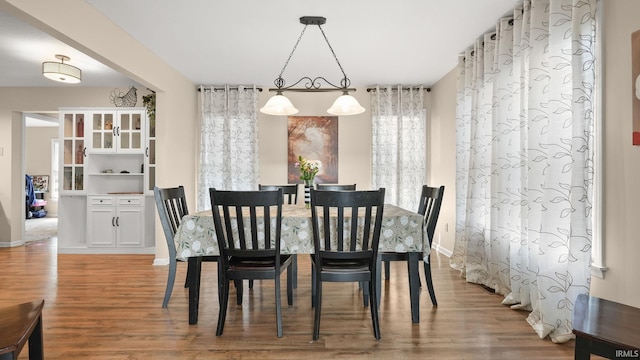 dining area with wood finished floors and baseboards