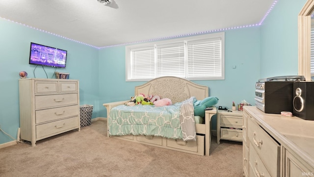 bedroom with baseboards and light colored carpet