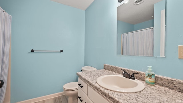 full bathroom with toilet, a shower with curtain, wood finished floors, vanity, and baseboards