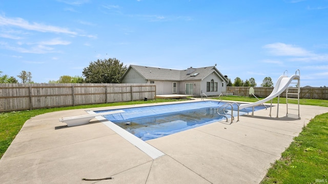 view of pool with a patio area, a water slide, a fenced backyard, a diving board, and a fenced in pool