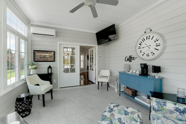 sunroom / solarium featuring ceiling fan and a wall mounted AC