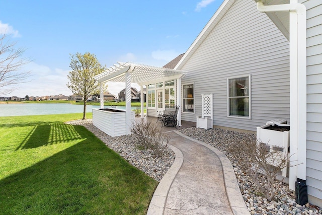 view of yard with a water view, a patio, and a pergola
