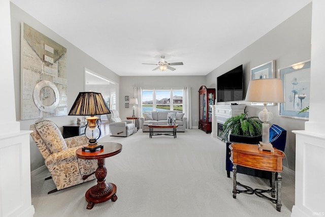 carpeted living area featuring ceiling fan