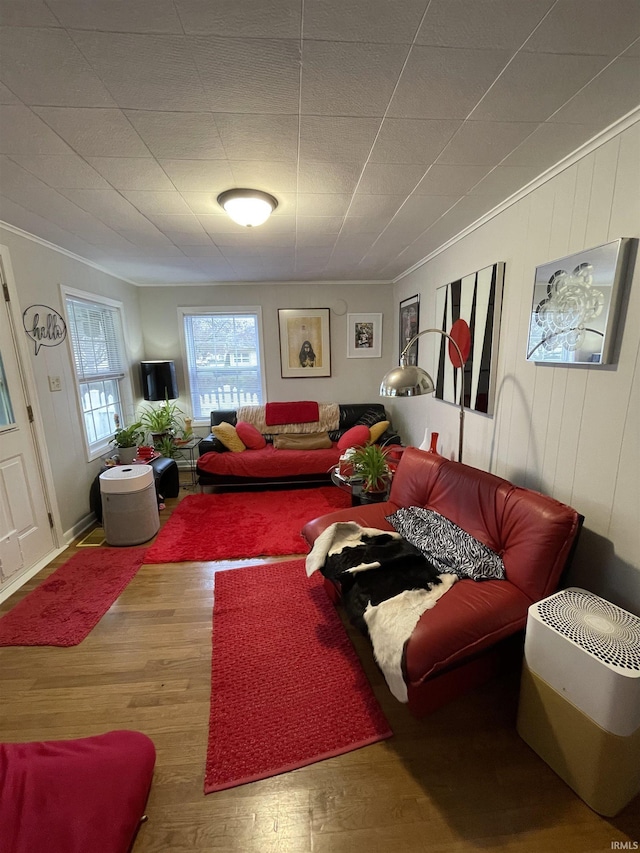 living area featuring crown molding and wood finished floors