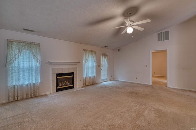 unfurnished living room with ceiling fan, a wealth of natural light, and visible vents