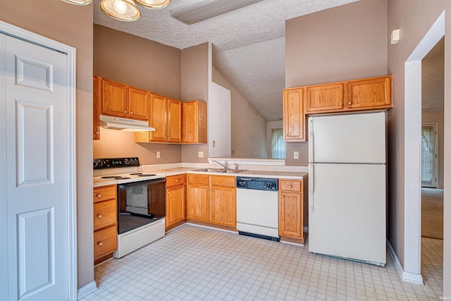 kitchen featuring under cabinet range hood, white appliances, a sink, vaulted ceiling, and light countertops