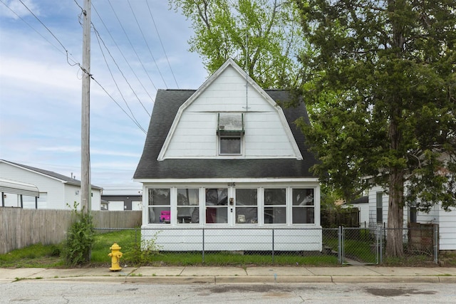 1116 Christyann St, Mishawaka, IN 46545 - exterior space with a fenced front yard, a shingled roof, and a gambrel roof