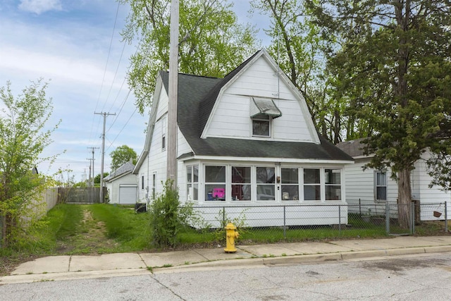 1116 Christyann St, Mishawaka, IN 46545 - dutch colonial featuring a fenced front yard, roof with shingles, and a garage