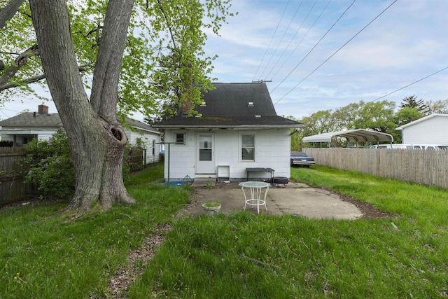 1116 Christyann St, Mishawaka, IN 46545 - rear view of property with a yard, roof with shingles, fence, and a carport