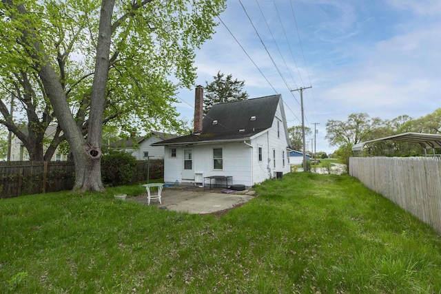1116 Christyann St, Mishawaka, IN 46545 - back of house featuring a patio, a chimney, a lawn, and a fenced backyard