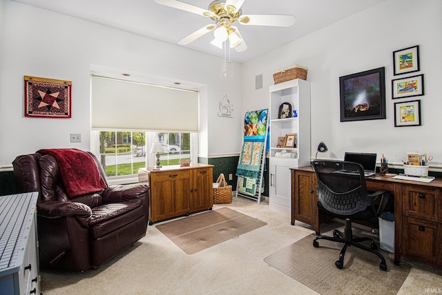 home office with light carpet, a ceiling fan, and visible vents