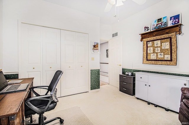 office featuring light colored carpet, visible vents, and ceiling fan