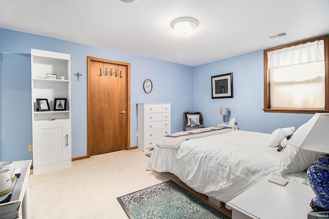 bedroom featuring light carpet and visible vents