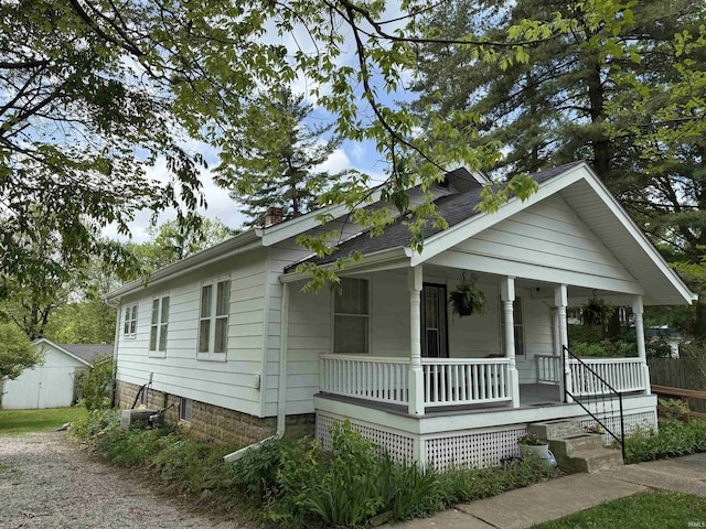 1406 E Hillside Dr, Bloomington, IN 47401 - bungalow-style home with a chimney and a porch