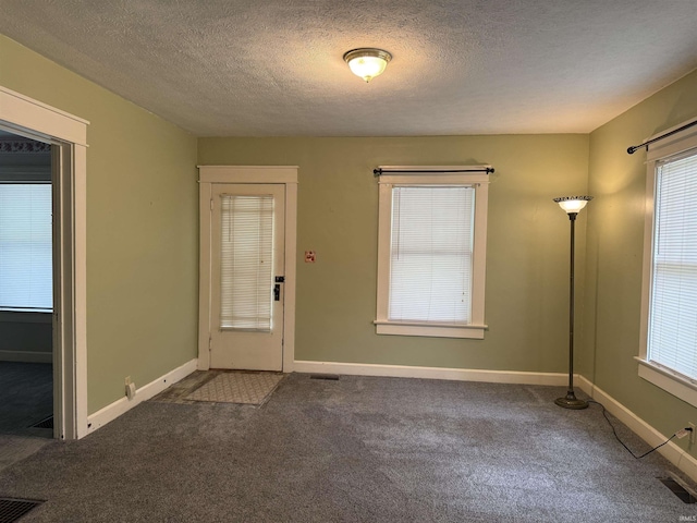 1406 E Hillside Dr, Bloomington, IN 47401 - entryway featuring a wealth of natural light, visible vents, and dark carpet