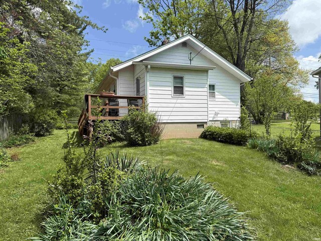 1406 E Hillside Dr, Bloomington, IN 47401 - view of home's exterior with crawl space, a wooden deck, and a lawn