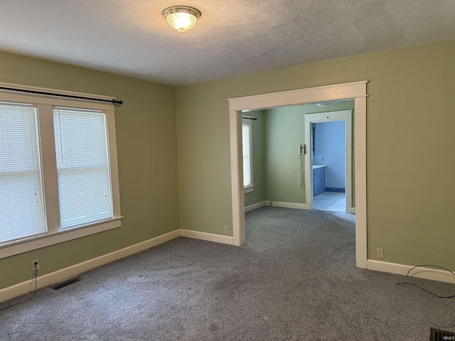 1406 E Hillside Dr, Bloomington, IN 47401 - spare room with plenty of natural light, visible vents, and carpet floors