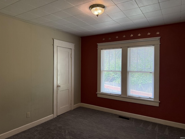 1406 E Hillside Dr, Bloomington, IN 47401 - empty room featuring visible vents, baseboards, and dark carpet