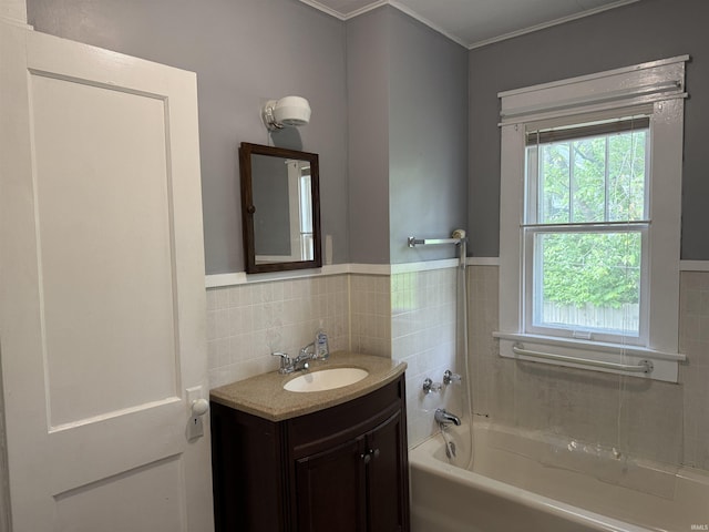 1406 E Hillside Dr, Bloomington, IN 47401 - full bathroom featuring tile walls, vanity, a tub to relax in, and a wainscoted wall