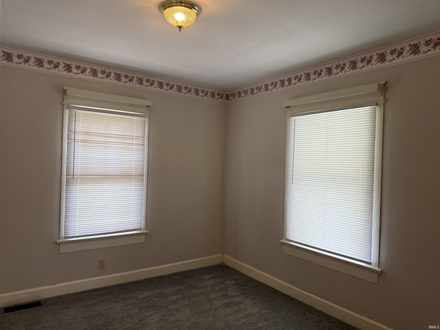 1406 E Hillside Dr, Bloomington, IN 47401 - unfurnished room featuring baseboards, a healthy amount of sunlight, and visible vents