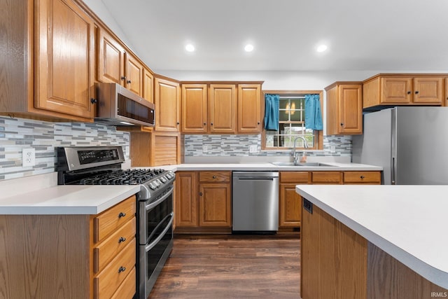 104 S Line St, South Whitley, IN 46787 - kitchen featuring a sink, dark wood-style flooring, light countertops, appliances with stainless steel finishes, and decorative backsplash