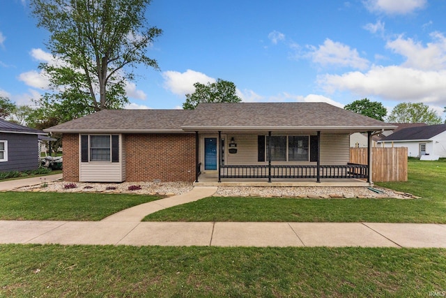 104 S Line St, South Whitley, IN 46787 - ranch-style house featuring covered porch, brick siding, and a front yard