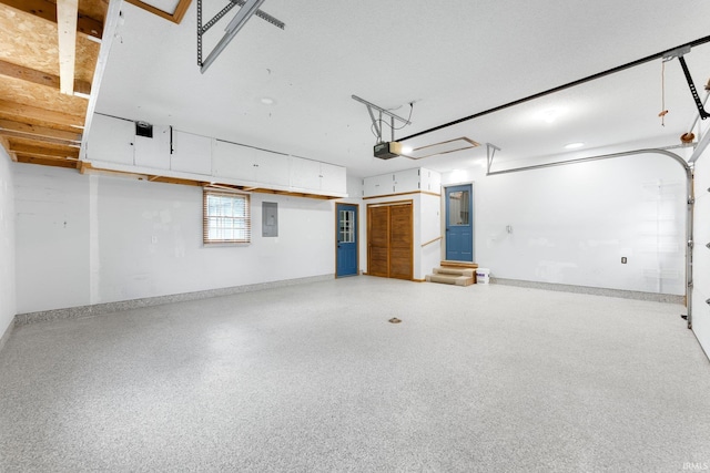 104 S Line St, South Whitley, IN 46787 - garage with baseboards, electric panel, and a garage door opener