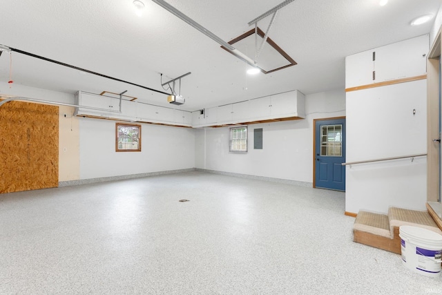 104 S Line St, South Whitley, IN 46787 - garage with baseboards, electric panel, and a garage door opener