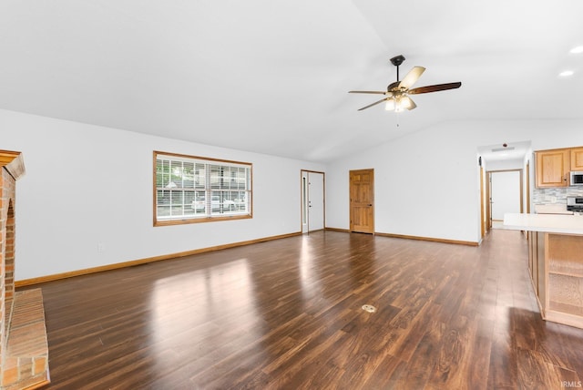 104 S Line St, South Whitley, IN 46787 - unfurnished living room featuring lofted ceiling, baseboards, a ceiling fan, and dark wood-type flooring