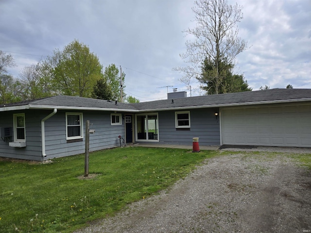 view of front of house featuring a chimney, a front yard, a garage, and driveway