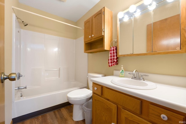 bathroom with vanity, toilet, shower / tub combination, and wood finished floors
