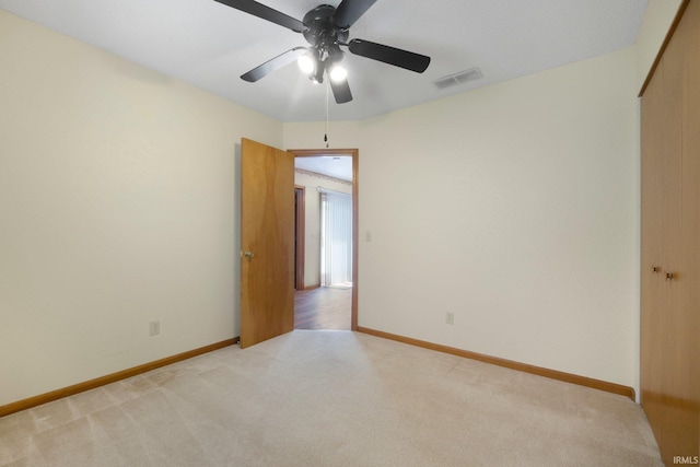 unfurnished bedroom with baseboards, light carpet, a closet, and visible vents