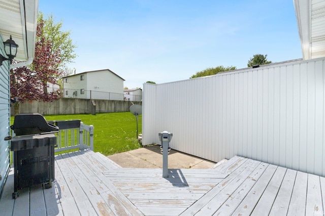deck featuring a yard and a fenced backyard